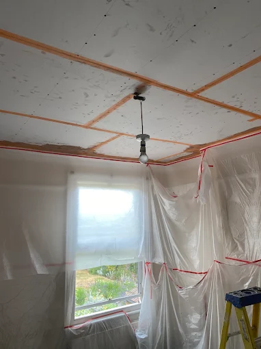 Ceiling boarded room sheeted for dust