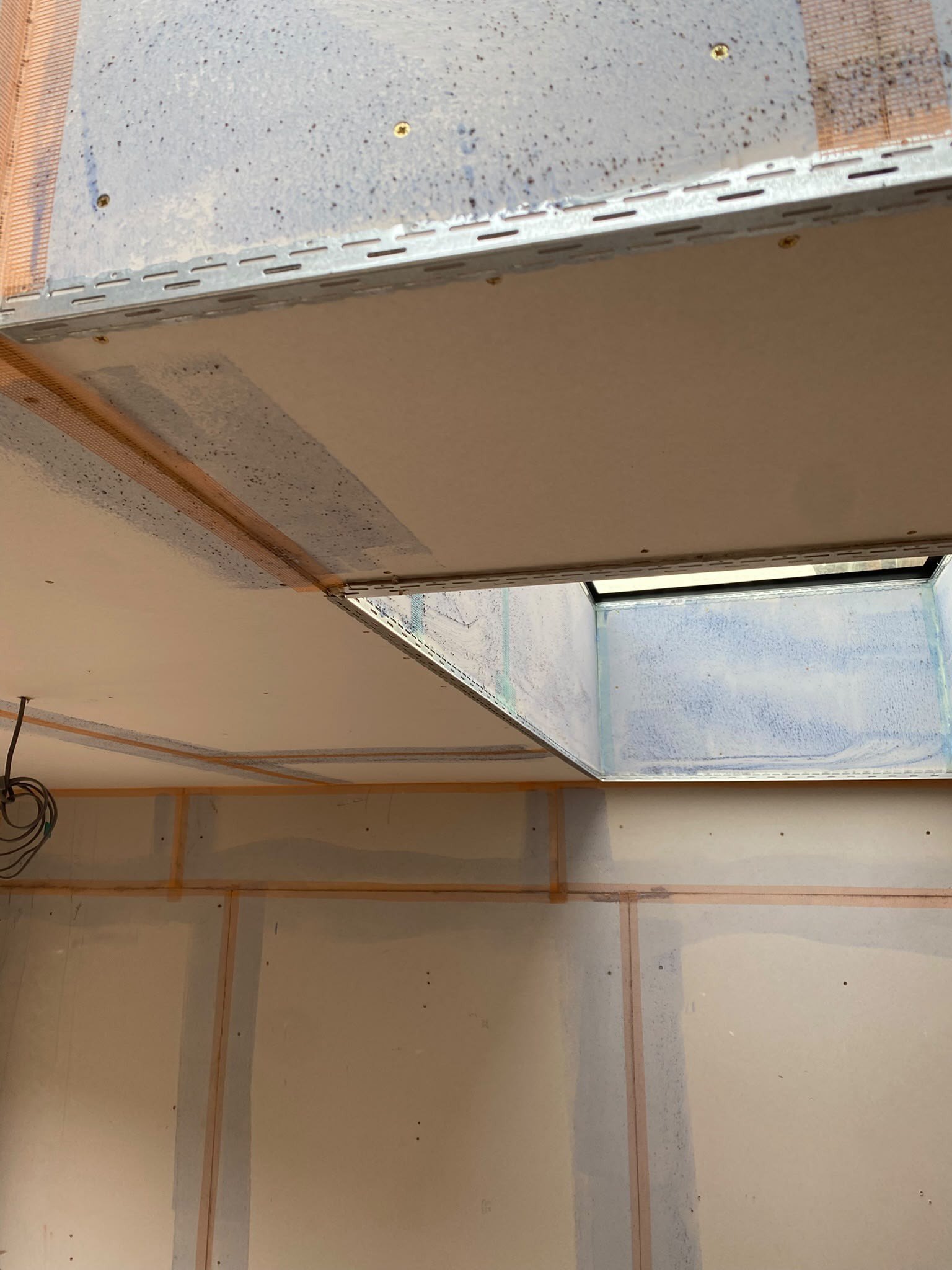 Ceiling boards taped and jointed, during