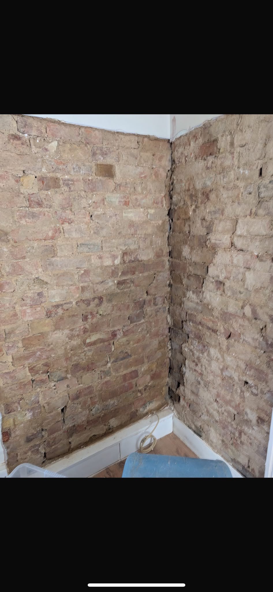 Corner stripped to brick at a crack, before