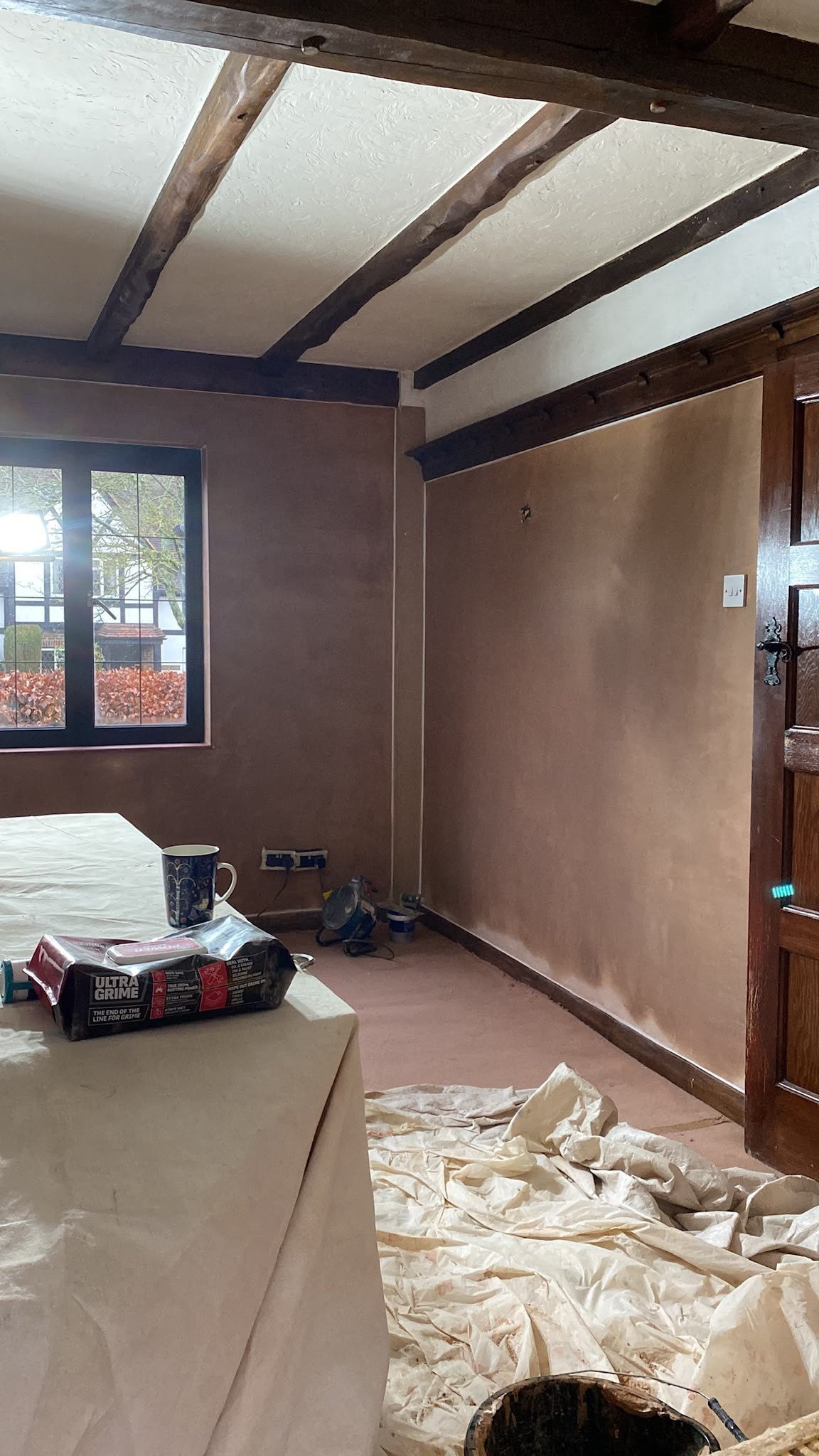 Beamed room skimmed under dust sheets, during