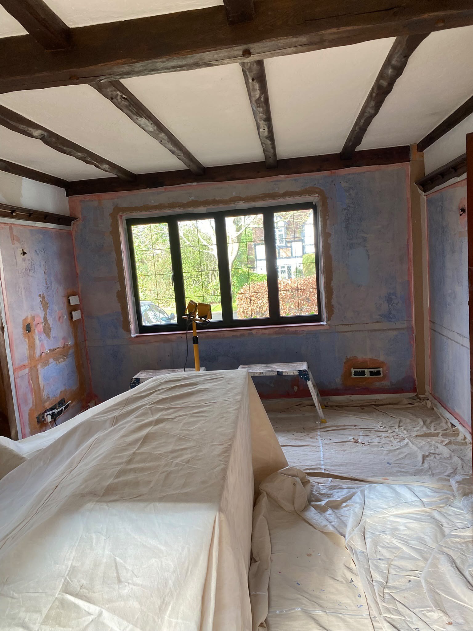 Beamed room stripped walls sheeted, before