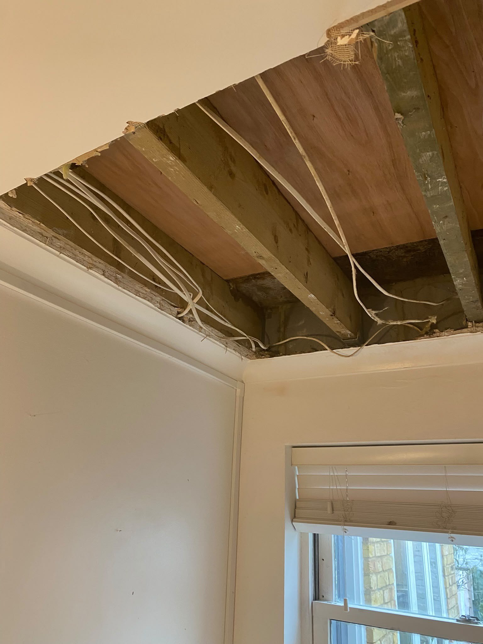 Ceiling opened to joists and old lath, before