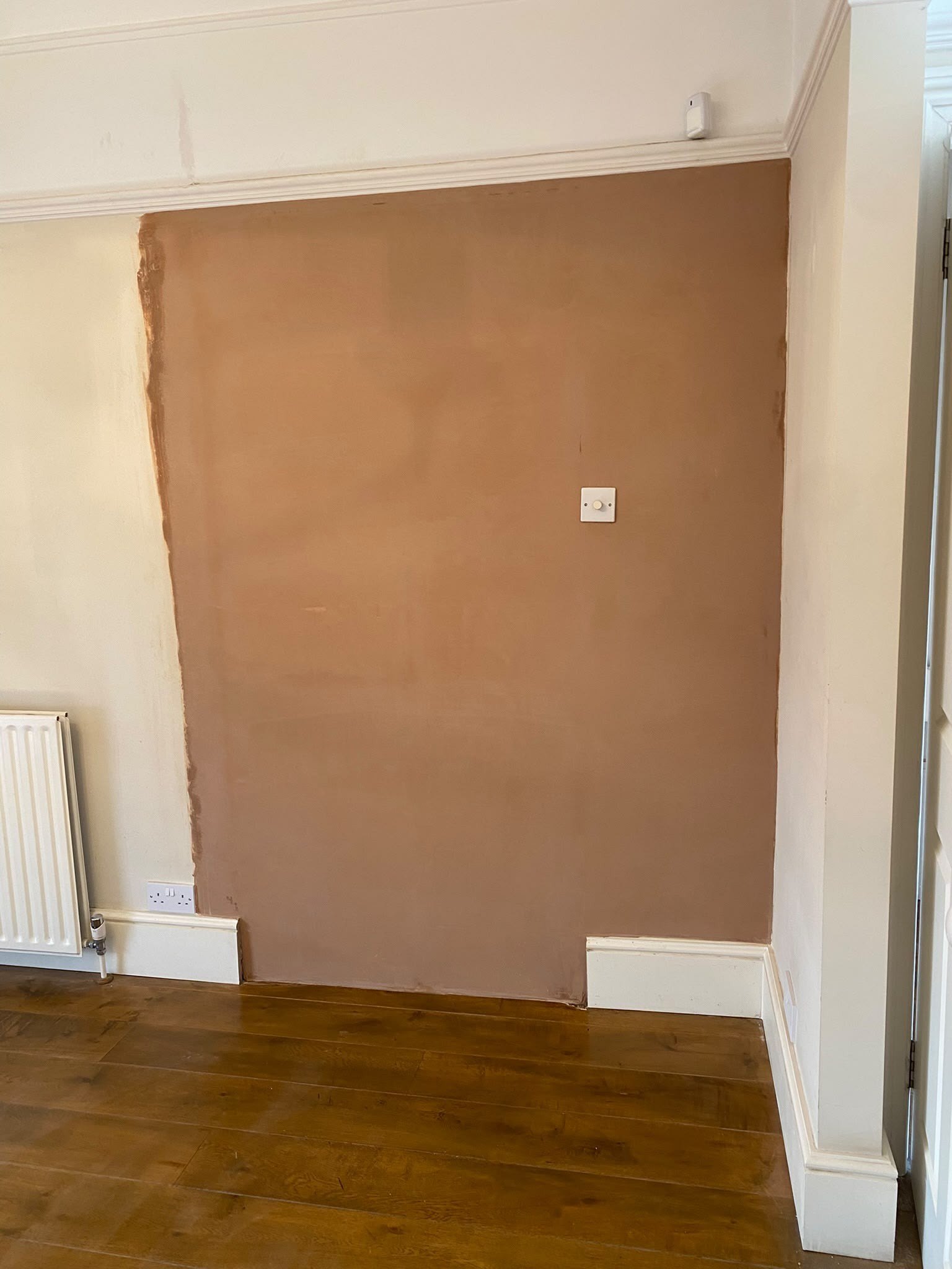 Wall skimmed above the radiator, after