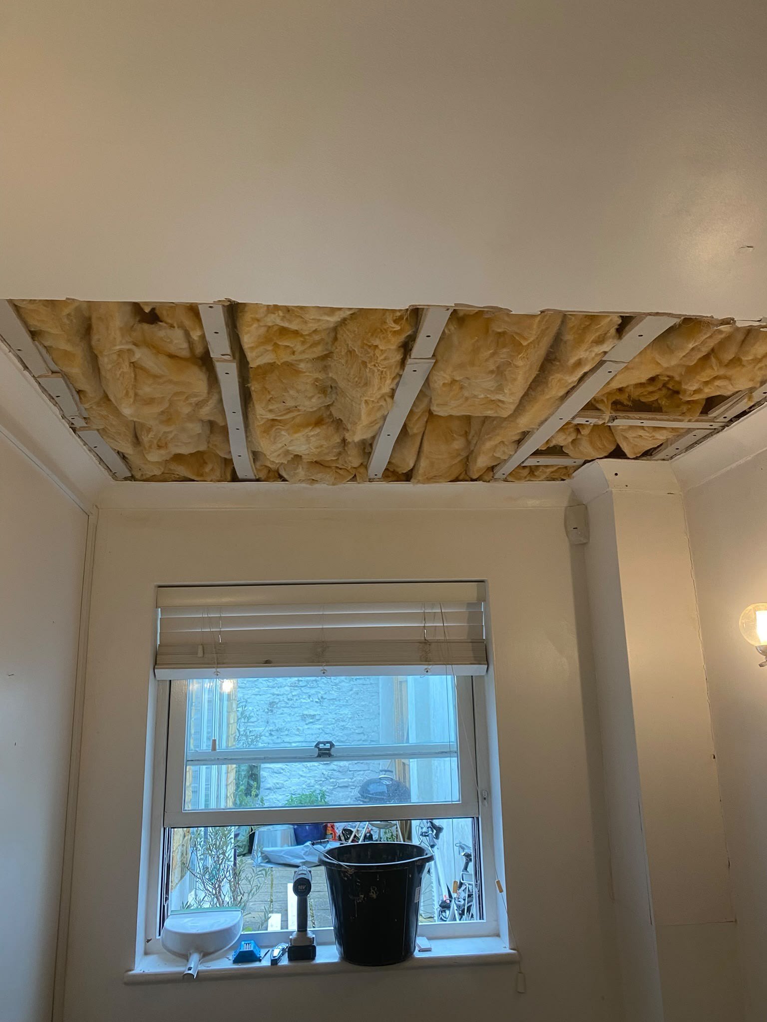Ceiling stripped to the insulation, before