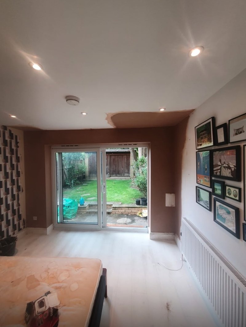 Living room ceiling patched by the patio doors, during