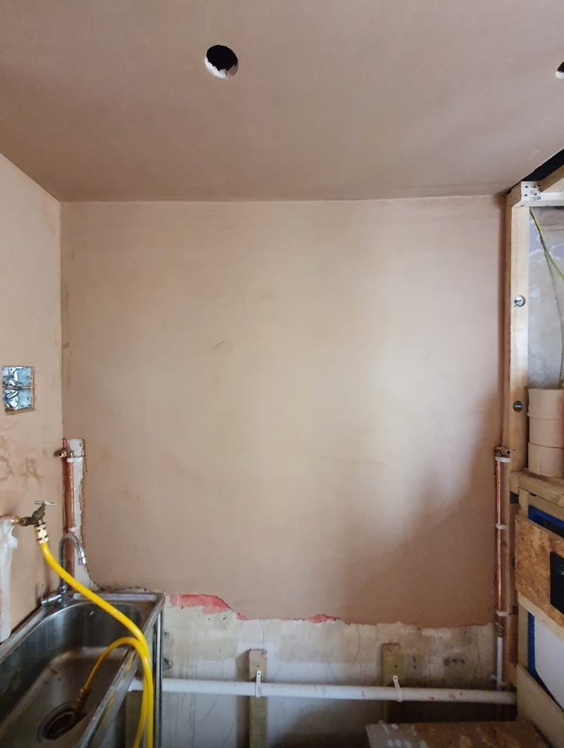 Kitchen wall and ceiling skimmed around the sink run, during