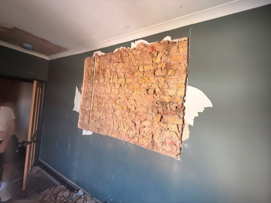Wall patch cut out back to brick, before