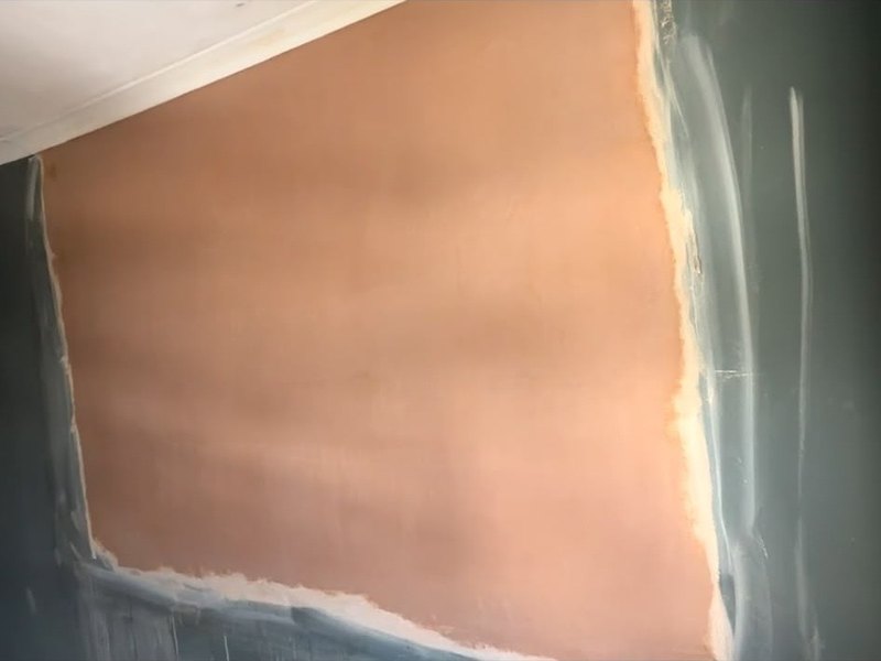 Wall patch made good and skimmed, after