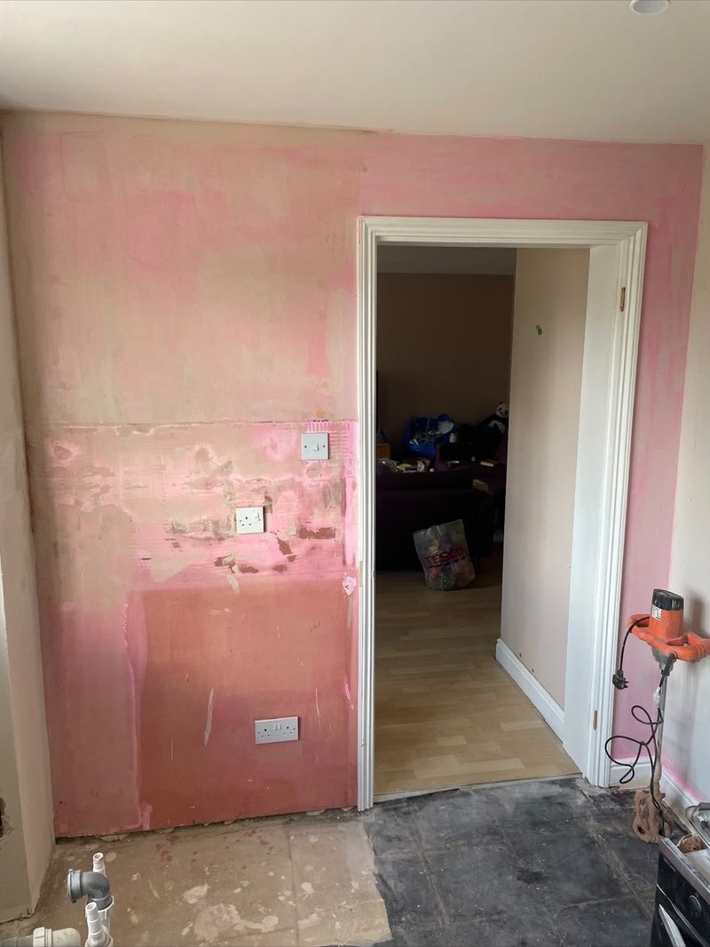 Room wall stripped and prepped, before