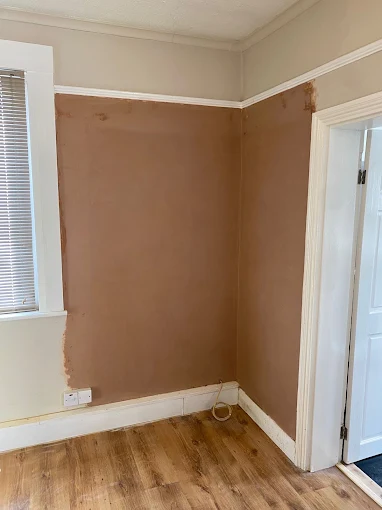 Skimmed wall next to door frame