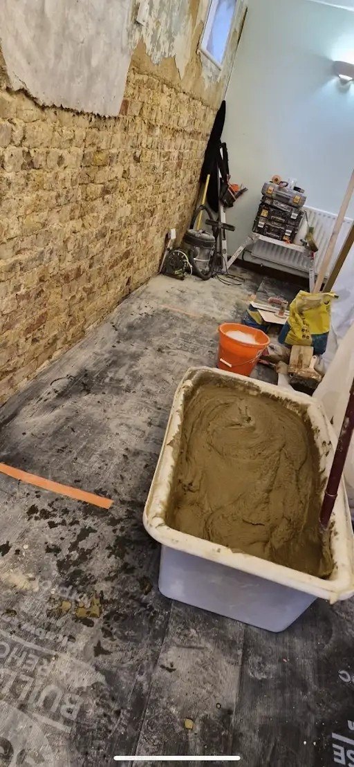 Sand and cement mixed for render, during