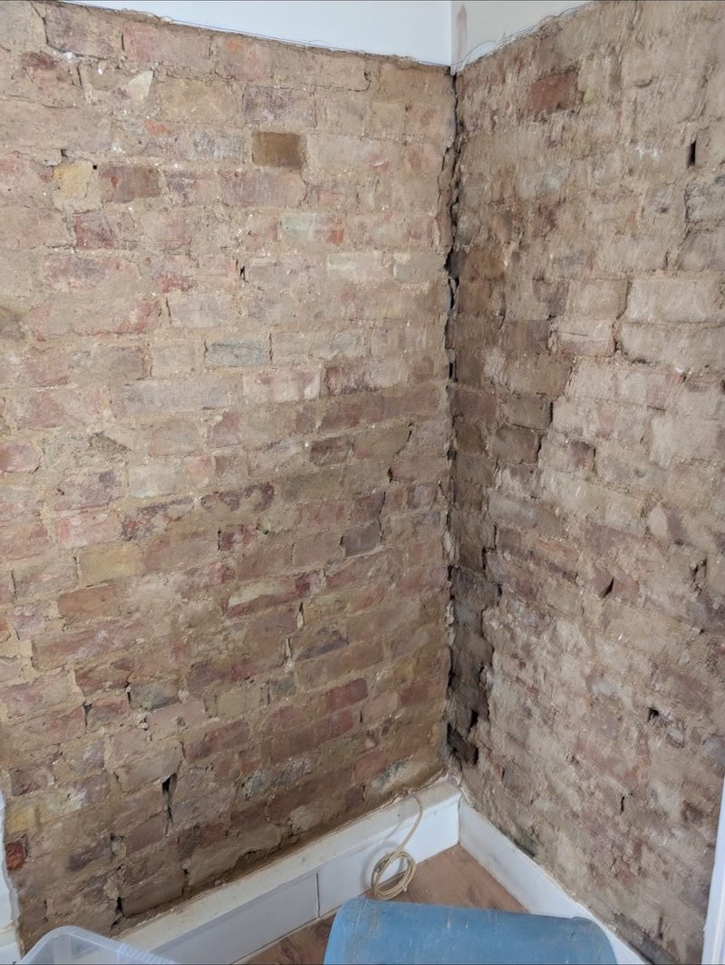 Brickwork exposed ready for plaster, before