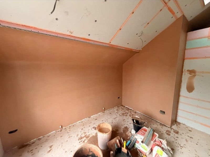Loft room skimmed beside the boarded wall, during