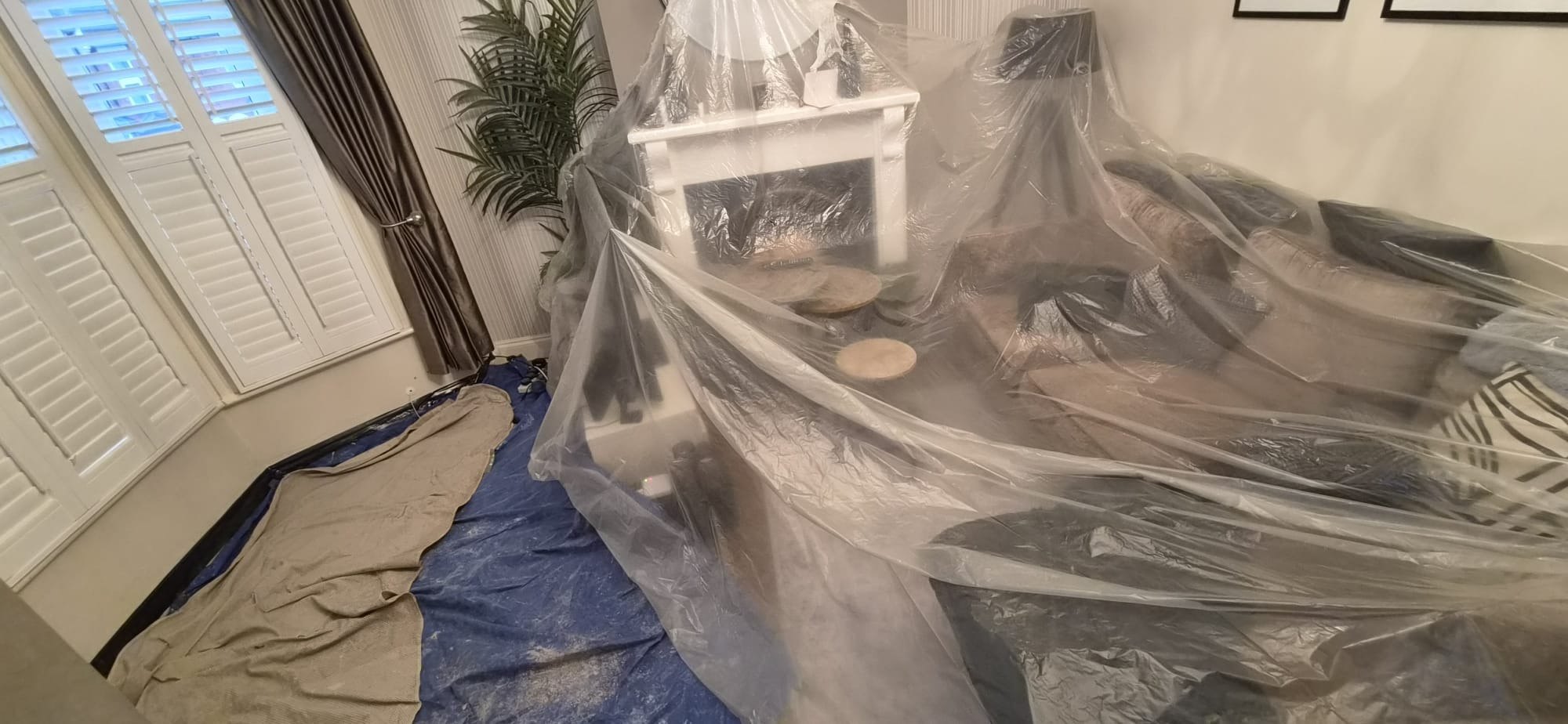Living room furniture sheeted, during