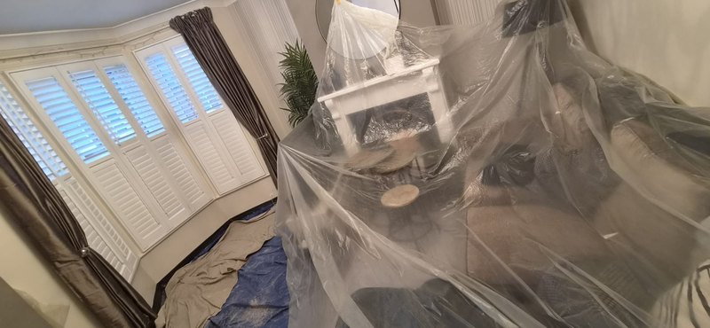 Living room sheeted wide, during
