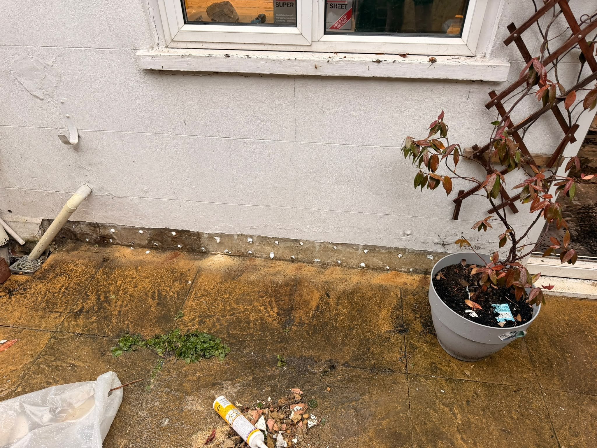 Damp proof course injection outside wall, during