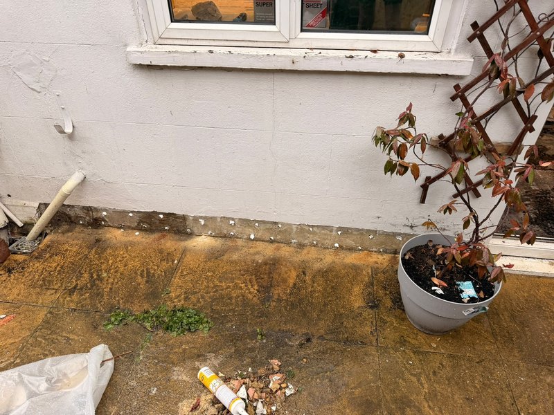 Damp proof course injection outside wall, during