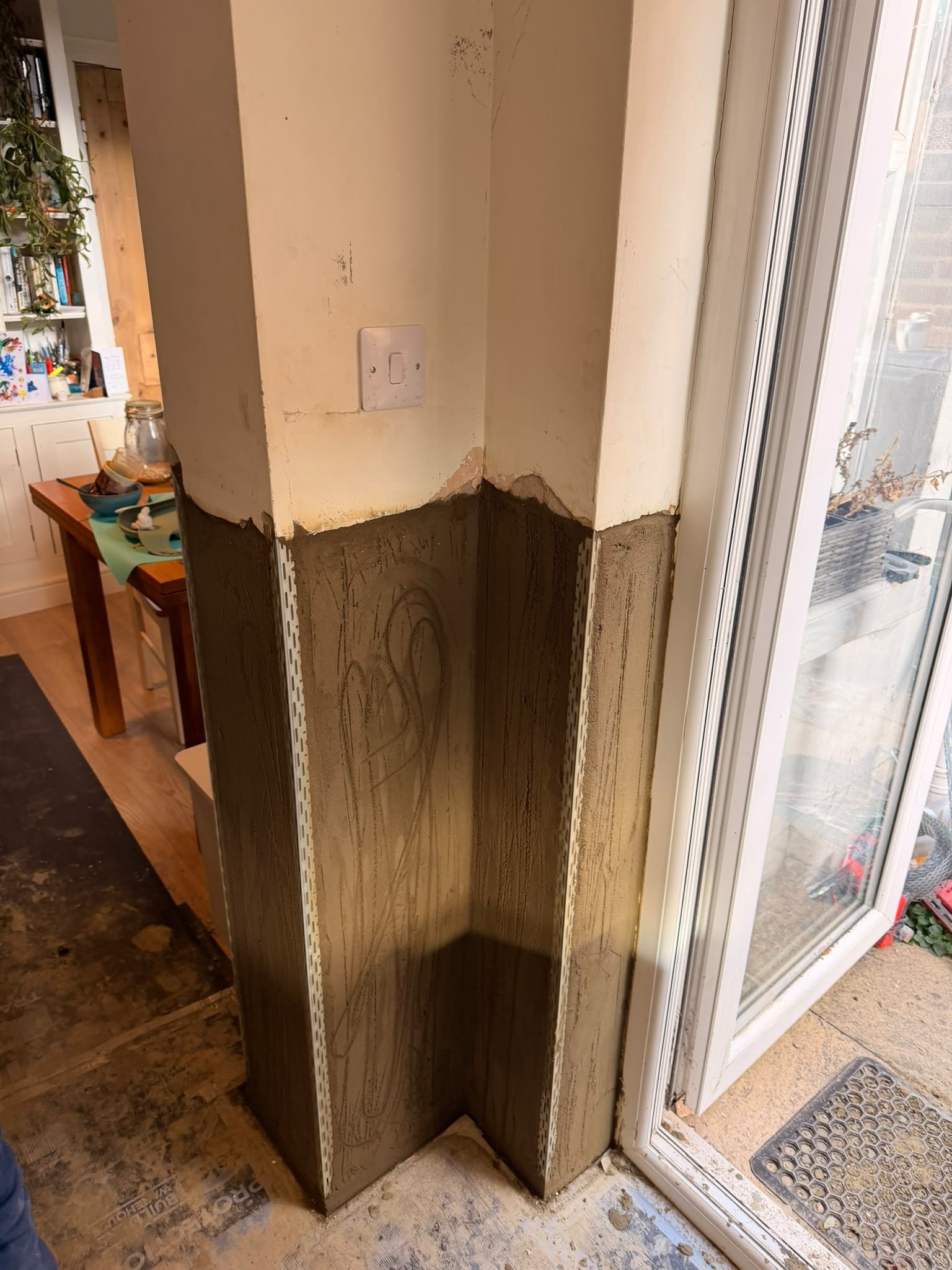 Damp door corner rendered wide, after