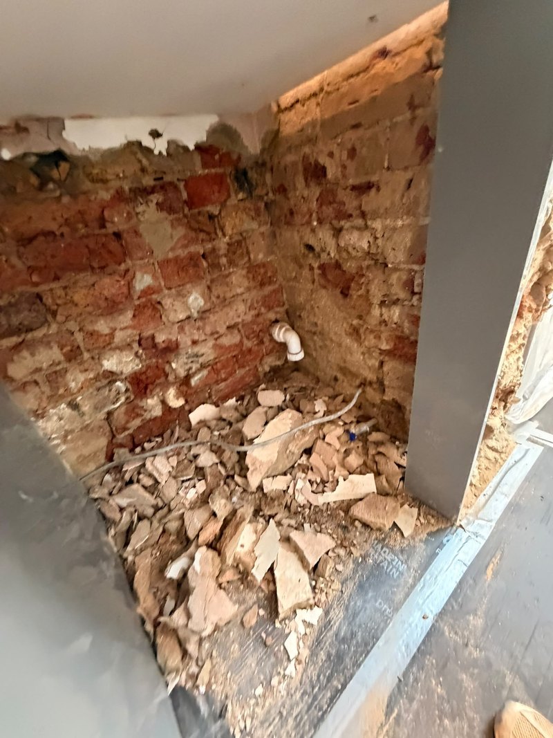 Kitchen under counter stripped, before
