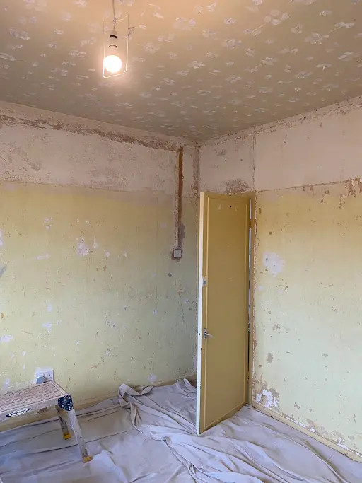 Bedroom stripped walls artex ceiling, before
