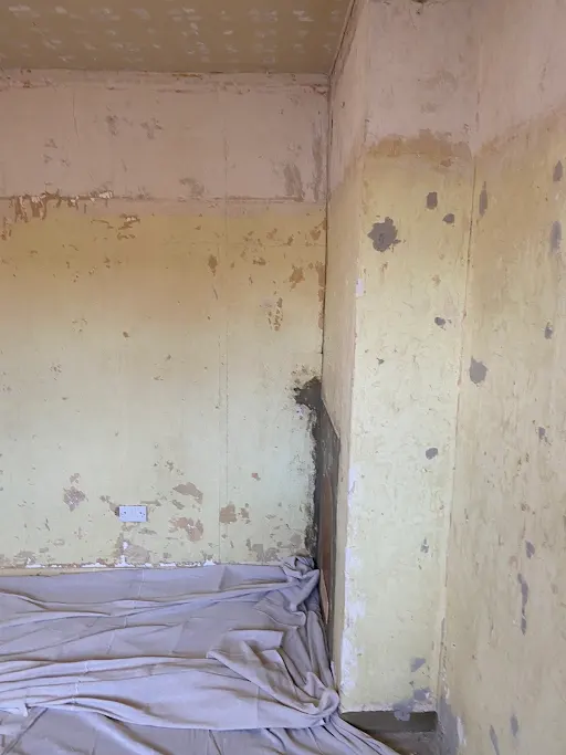 Flaking plaster corner before close up