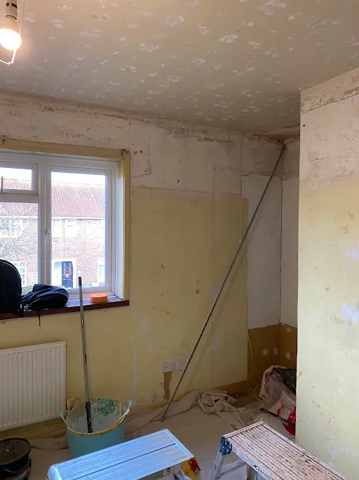 Bedroom window wall stripped, before