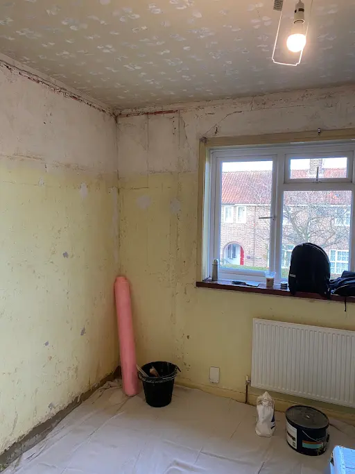 Bedroom corner stripped before window