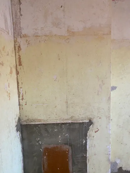 Old plaster chimney breast before close up