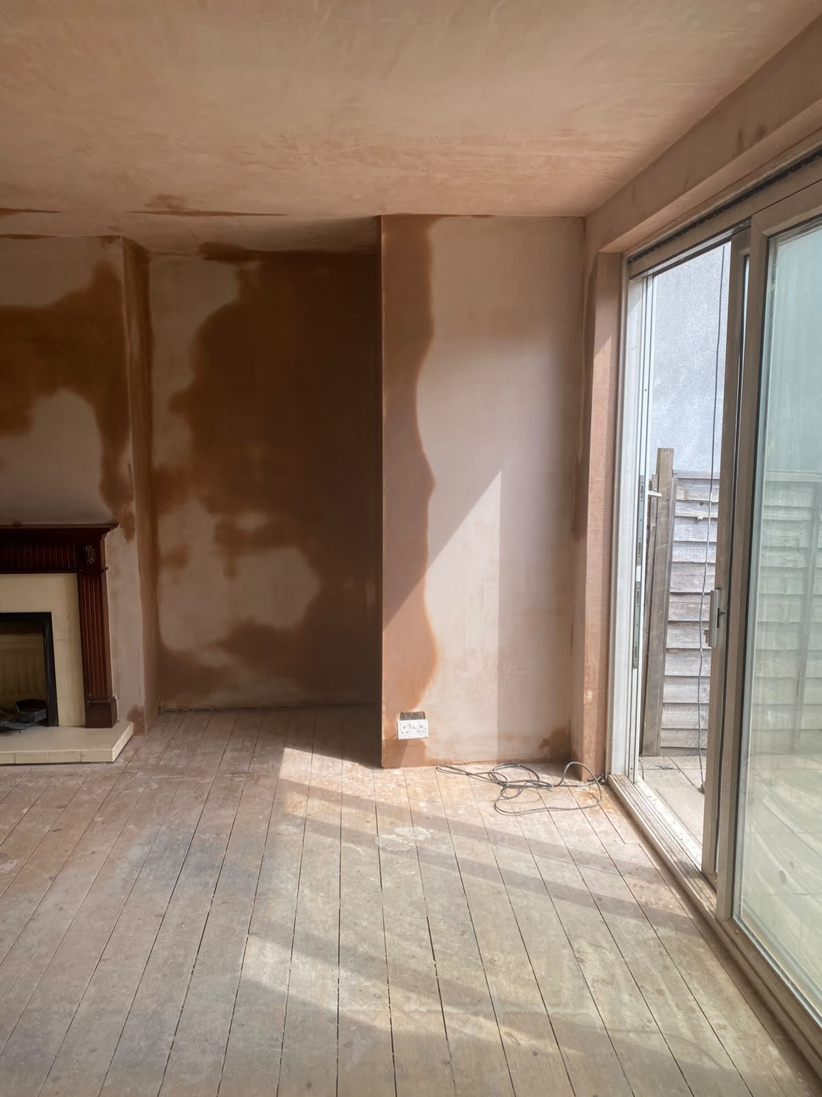 Living room skimmed by patio doors, after