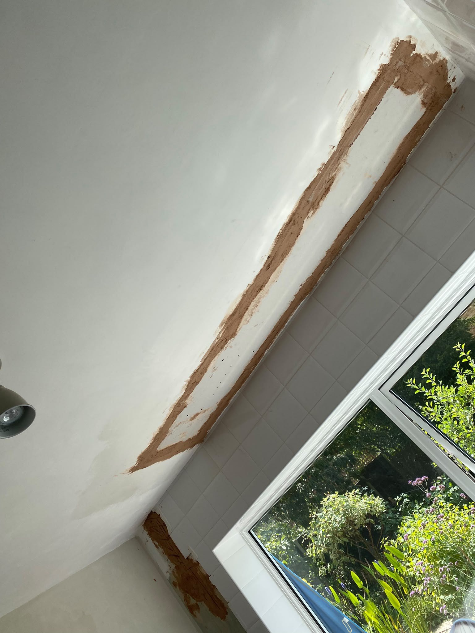 Ceiling band bonded over window, during