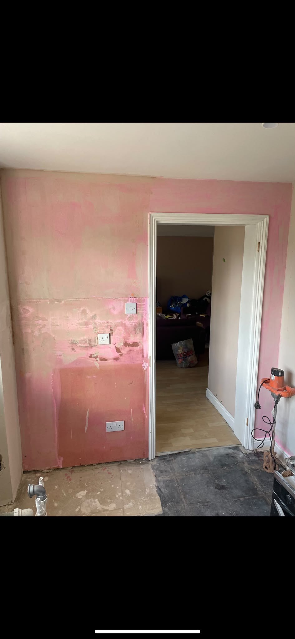 Wall stripped of old paint by doorway, before