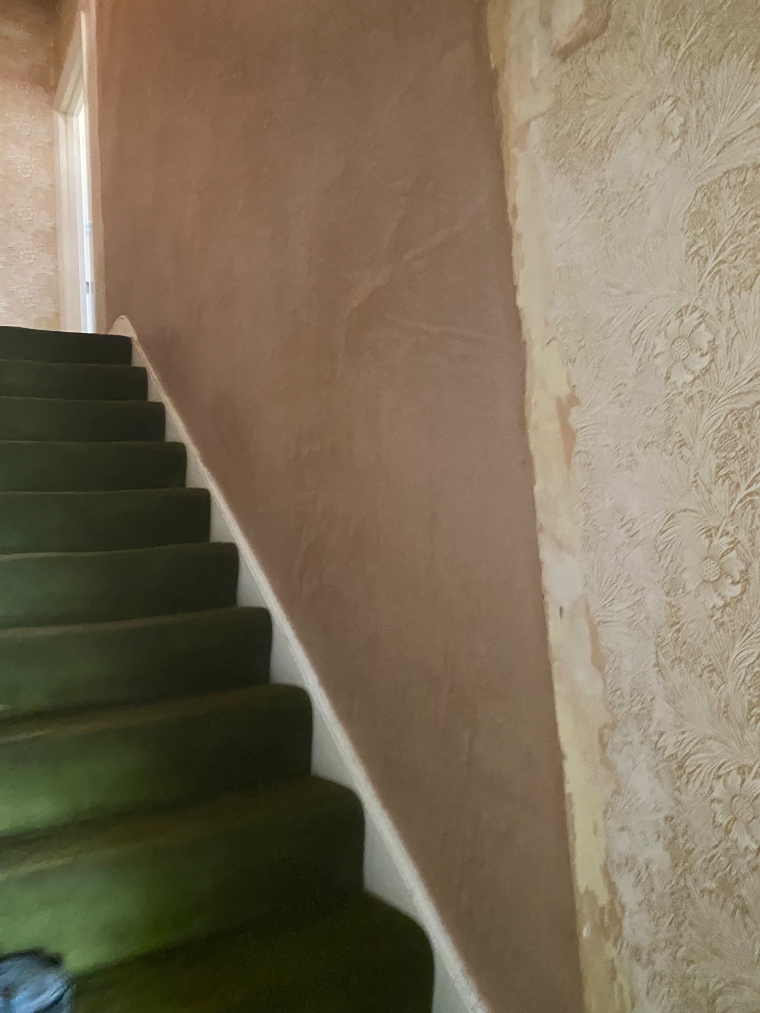 Stairwell wall skimmed above carpet, after