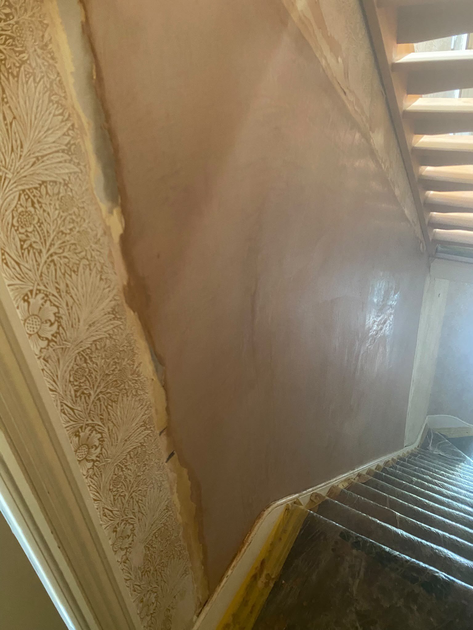Stairwell wall skimmed above dado, after