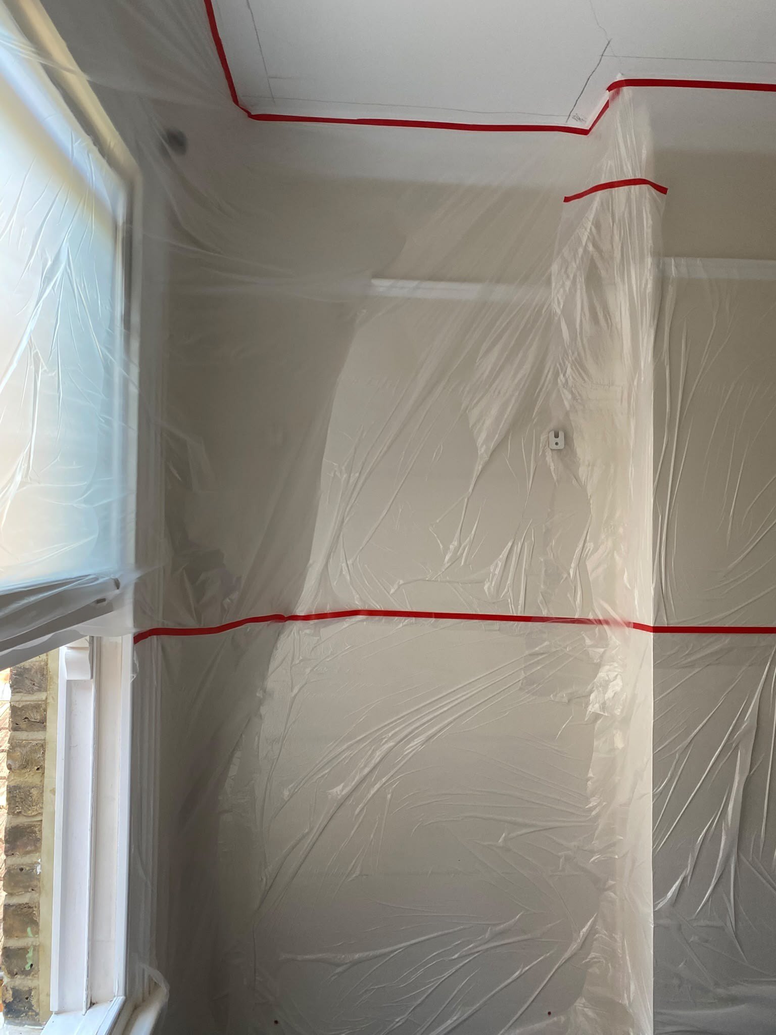 Room sealed in plastic sheeting, during